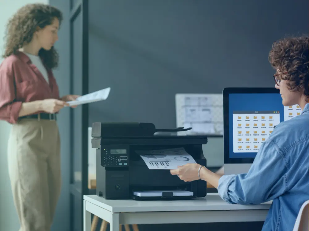 Technician performing on-site printer service and setup